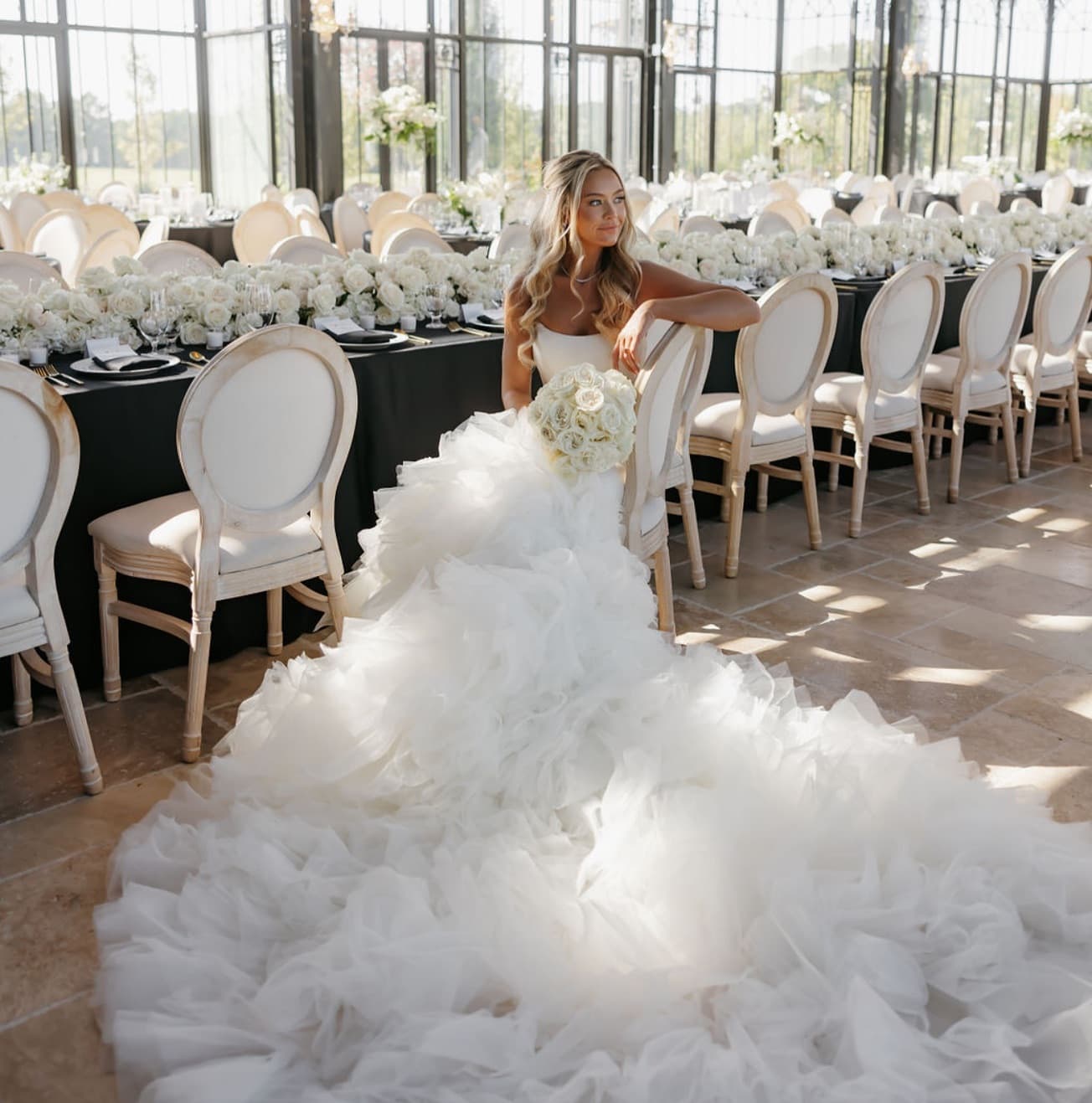 Bride with long curls and natural glam makeup in a tulle gown