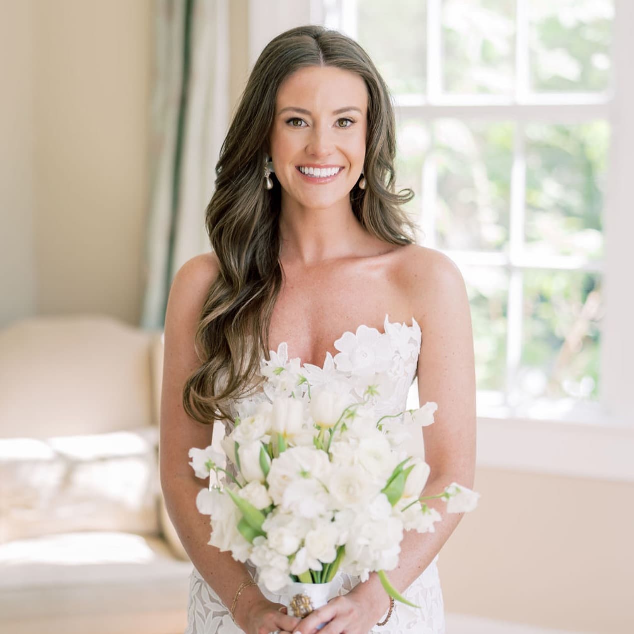 Bride with side-swept waves and radiant soft glam makeup